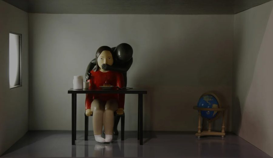 Figure in red dress seated at desk with black balloon shadow, 2021